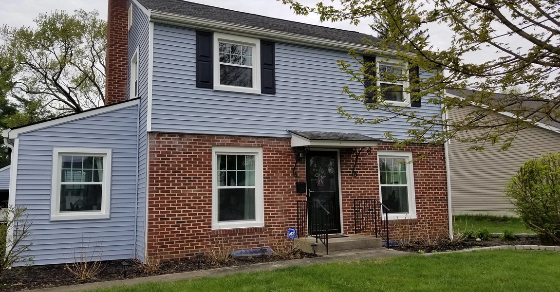 Columbus, OH home with fresh vinyl siding, modern roof, and seamless gutters installed by local professionals.