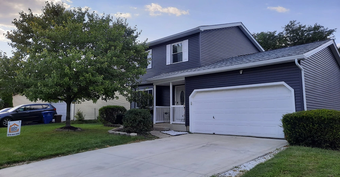 Hilltop, OH home featuring new vertical house siding in trending 2023 siding colors, installed by Columbus Windows & Siding